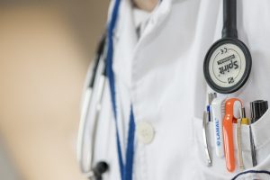 close up of a stethoscope and a doctor's coat