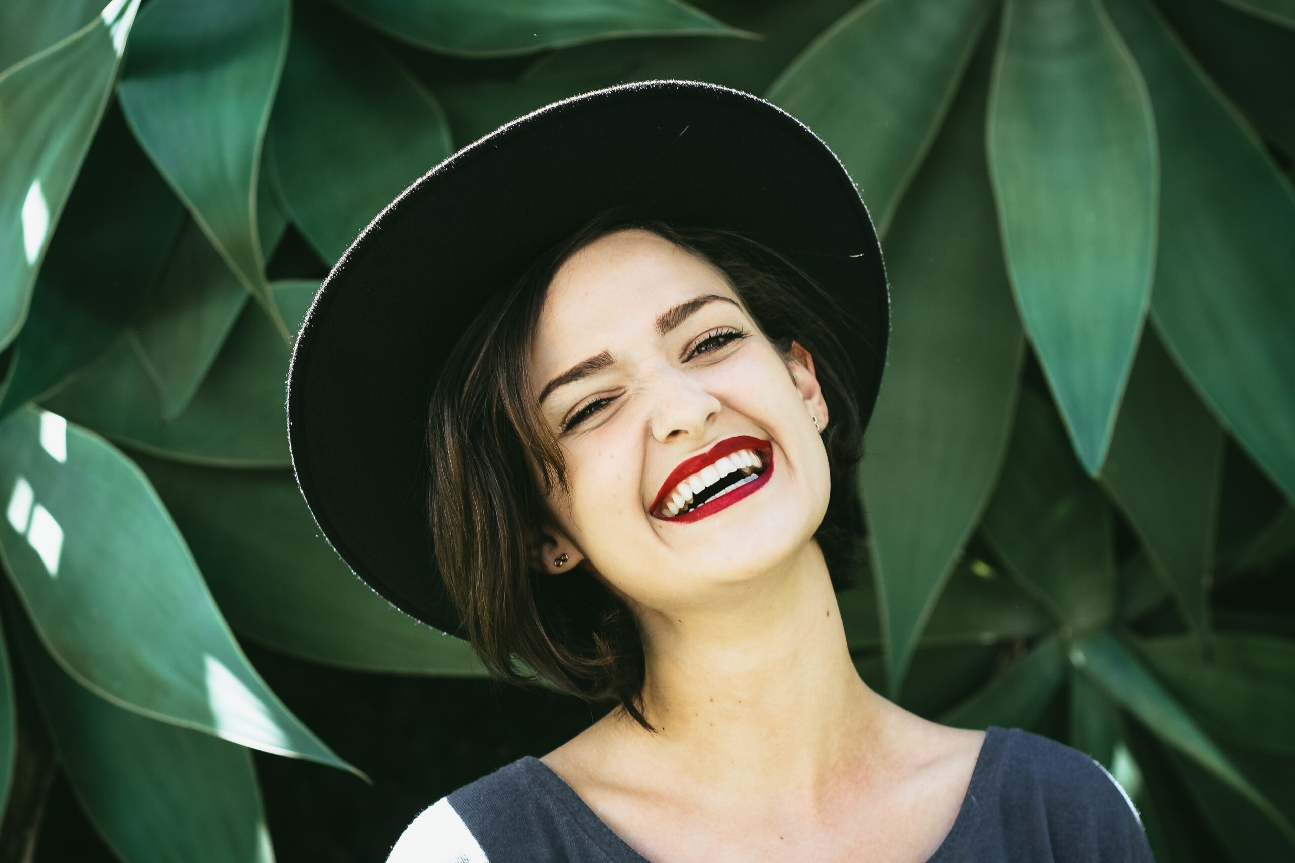 woman with a hut smiling